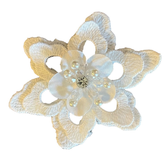 Decorative flower with a central gem on a white background