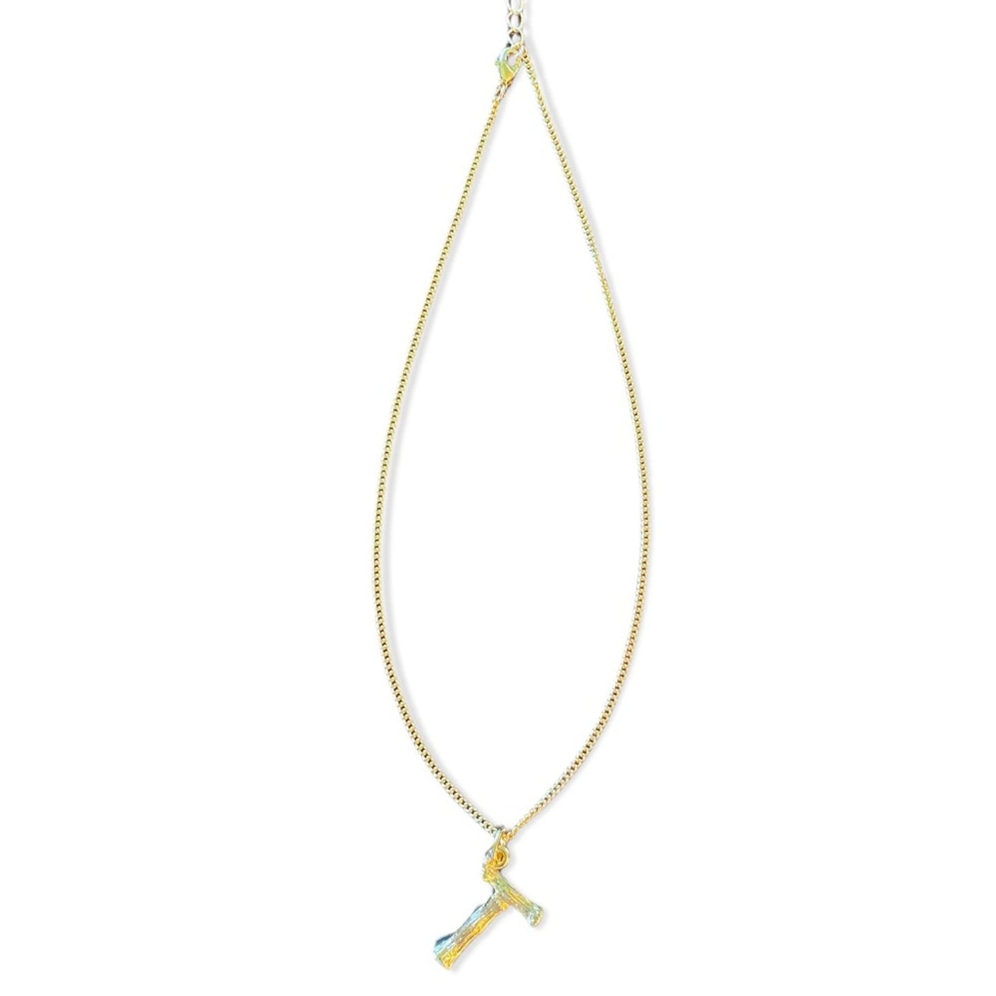 A delicate gold chain necklace featuring a small pendant shaped like a T with a light blue feather accent, displayed against a solid white background.