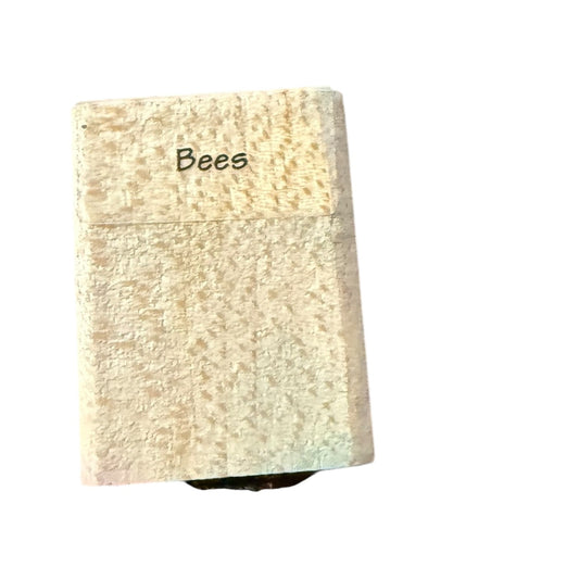 Wooden block with 'Bees' written on a white background