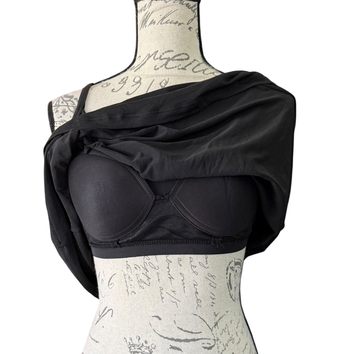Black tank top with showing built in bra on a mannequin against a white background