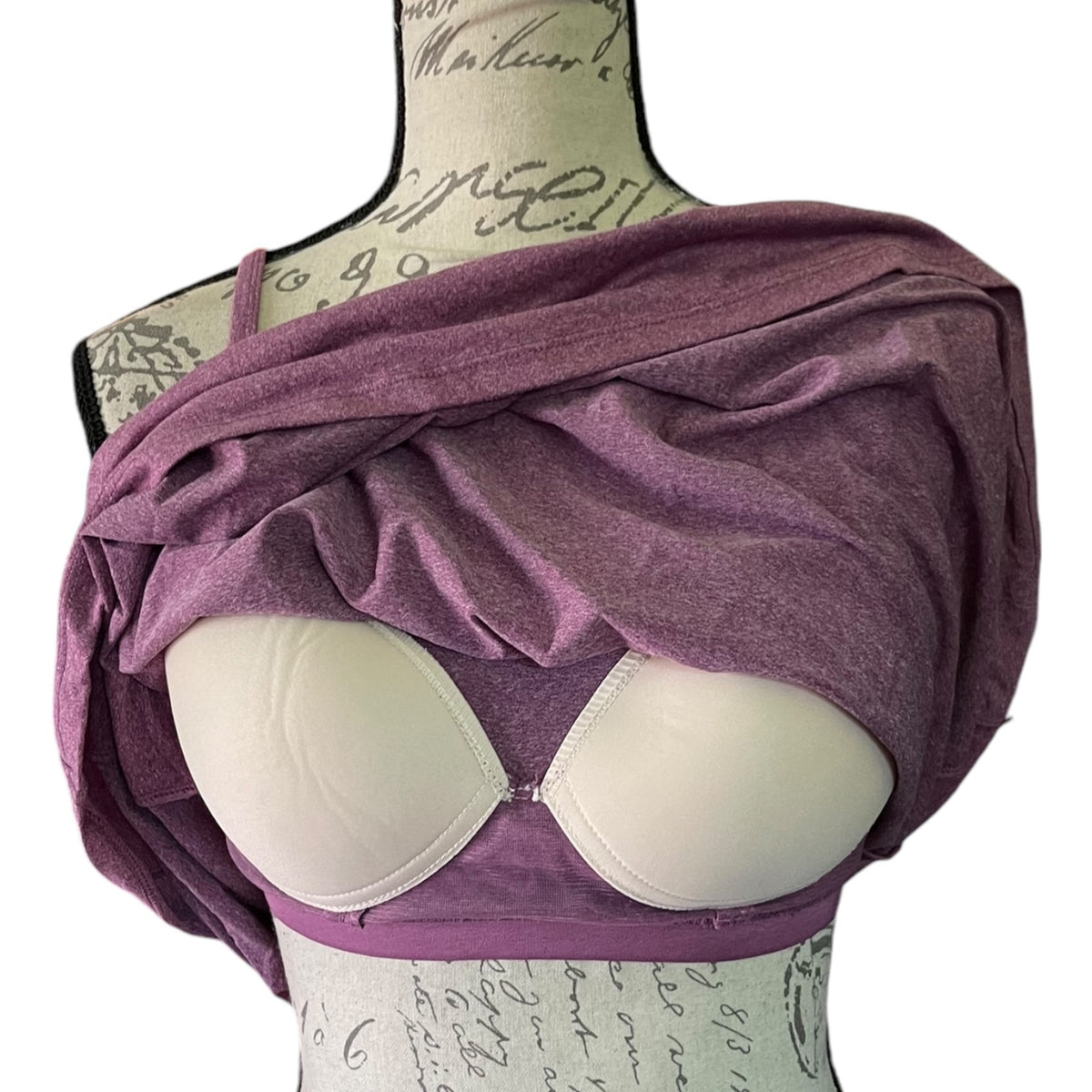 Purple top with built in bra on a mannequin against a white background