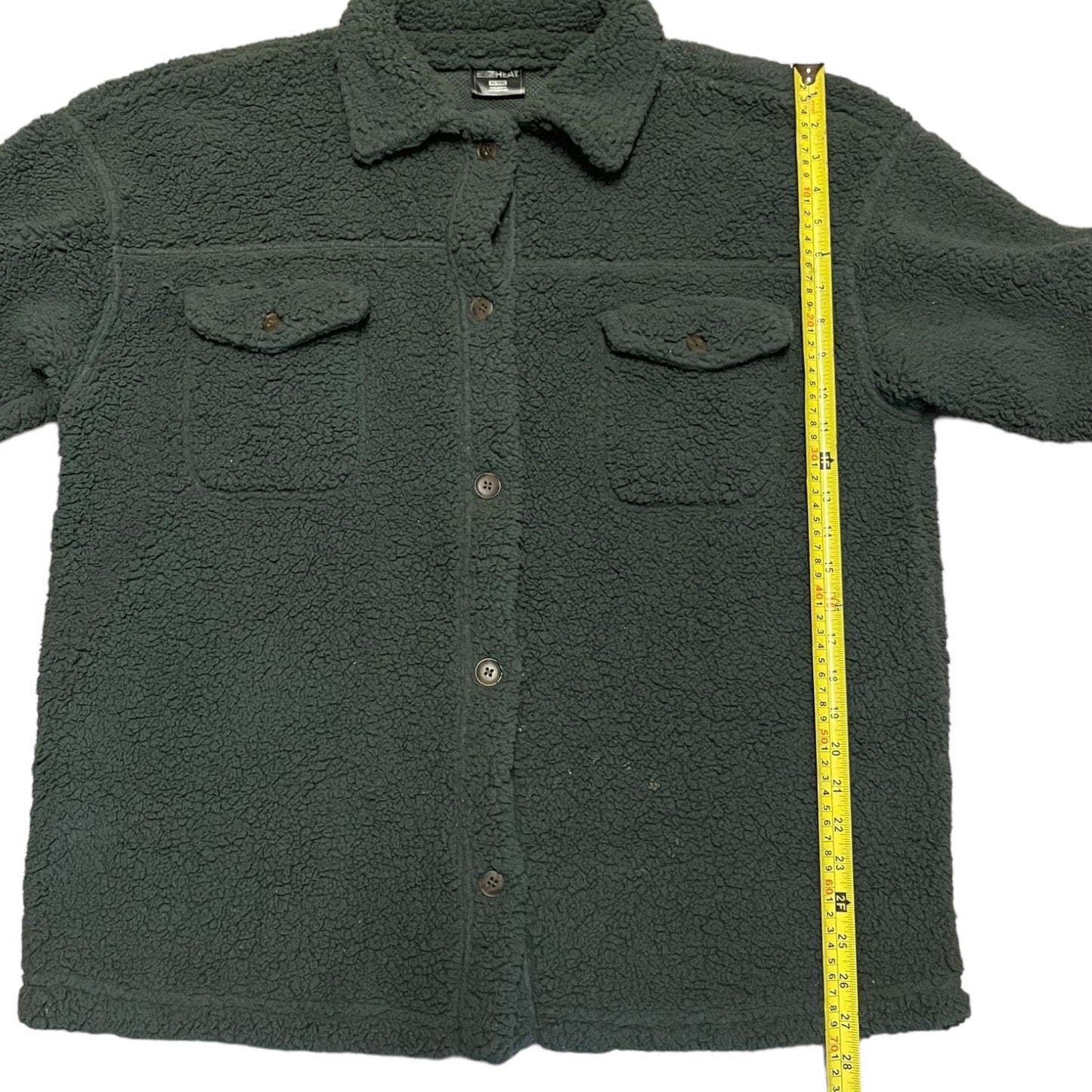 Gray fleece shirt with a measuring tape on a white background