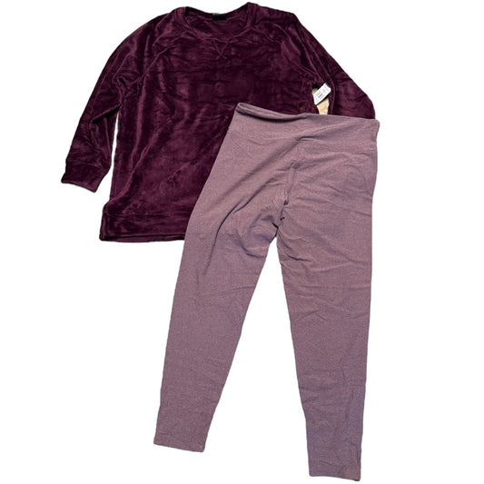 A two-piece pajama set featuring a plush, long-sleeve crewneck top in deep plum purple and matching leggings in a purple color, laid flat on a white background.