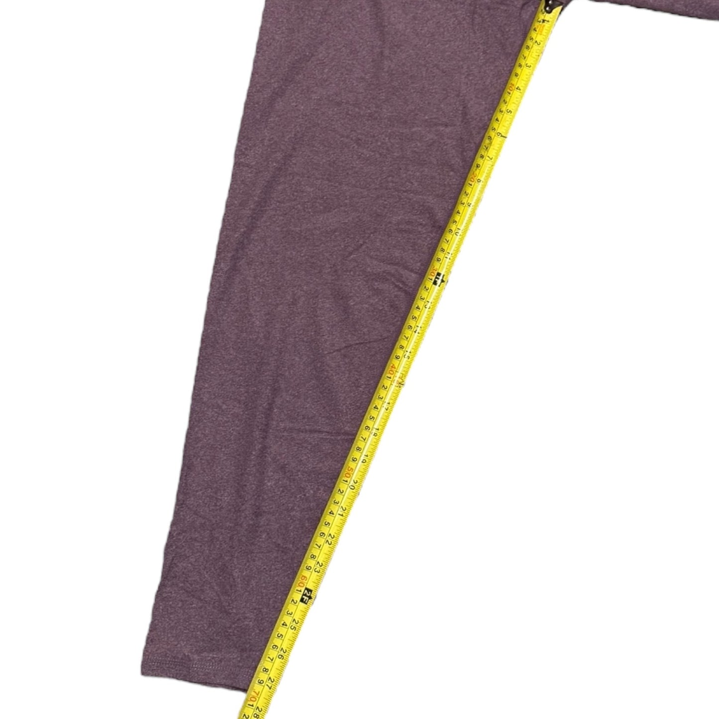 Purple leggings inseam with a yellow measuring tape on a white background