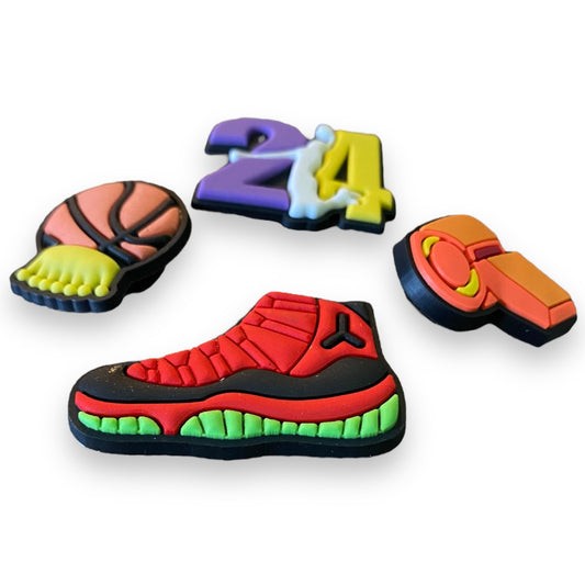 A set of colorful basketball-themed shoe charms on a plain white background, including a basketball, the number 24, a whistle, and a high-top basketball shoe.