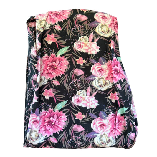 A folded black , pink multicolor leggings on plain white background.