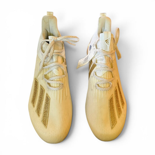 Pair of cleats with white laces on a light gray background