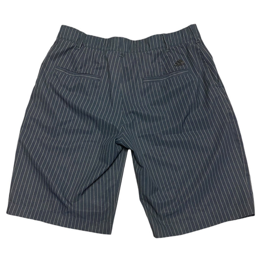 A pair of shorts featuring a gray base with thin white vertical pinstripes, shown from the back against a plain white background.