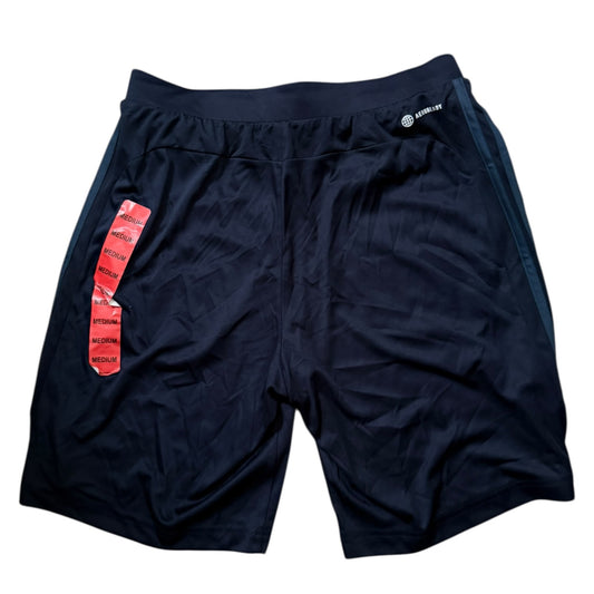 Back of blue shorts with a red tag on a white background