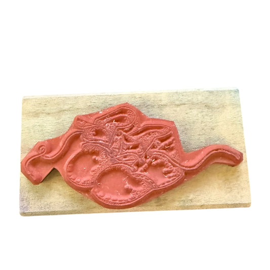 Bottom of stamp on a wooden block with a white background