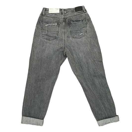Gray washed denim jeans shown from the back, featuring a straight-to-slightly-relaxed leg with rolled cuffs and classic back pocket stitching.