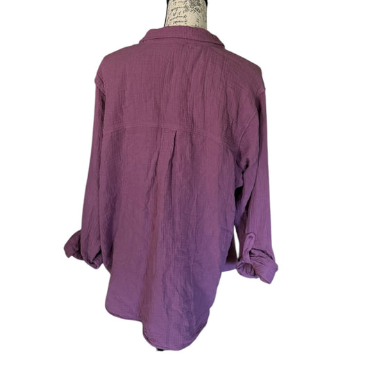 Back of Purple shirt on a mannequin with a white background