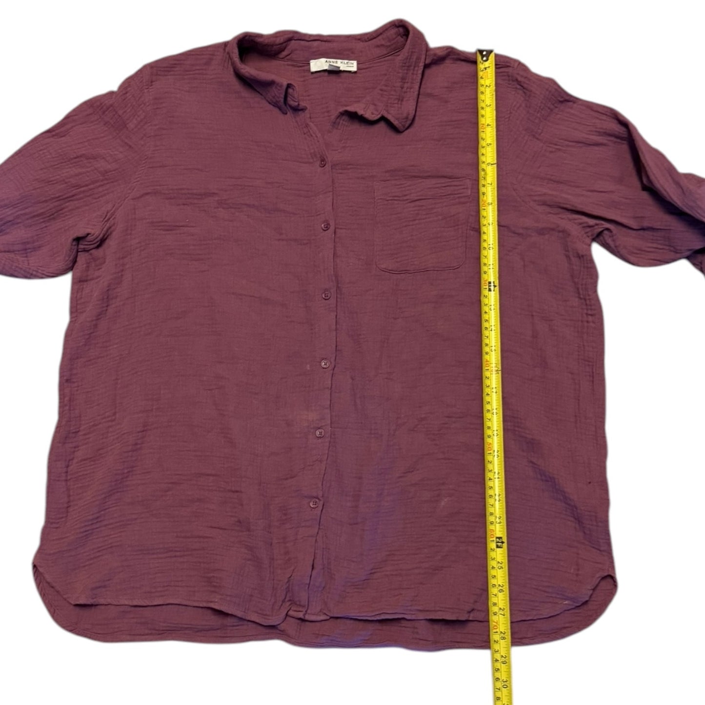 Purple shirt with a measuring tape on a white background