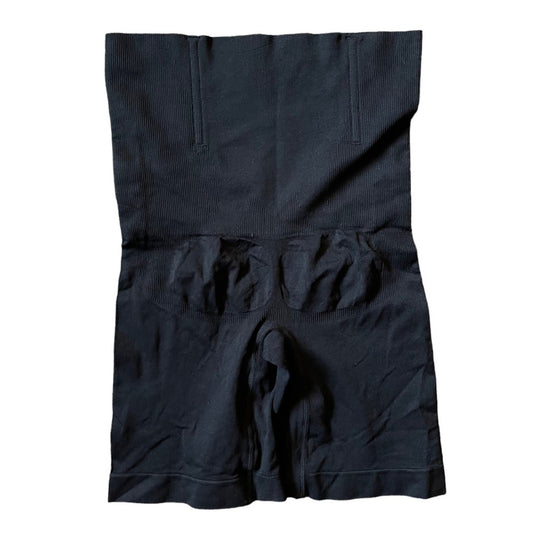 Black high waisted shapewear laid flat on a white background.