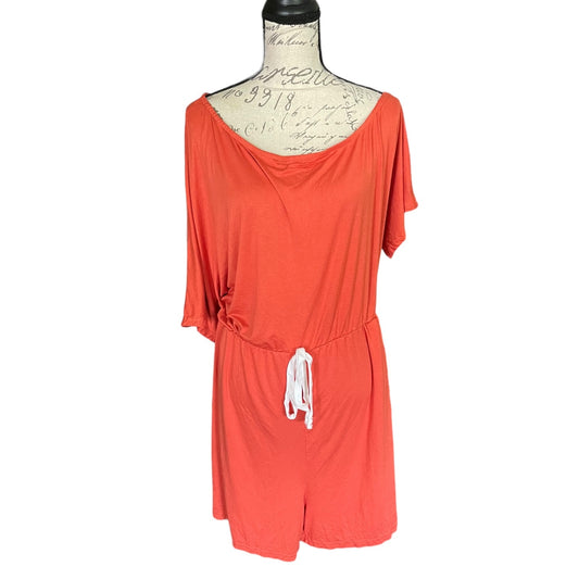 A coral orange short-sleeve romper displayed on a dress form mannequin against a plain white background.