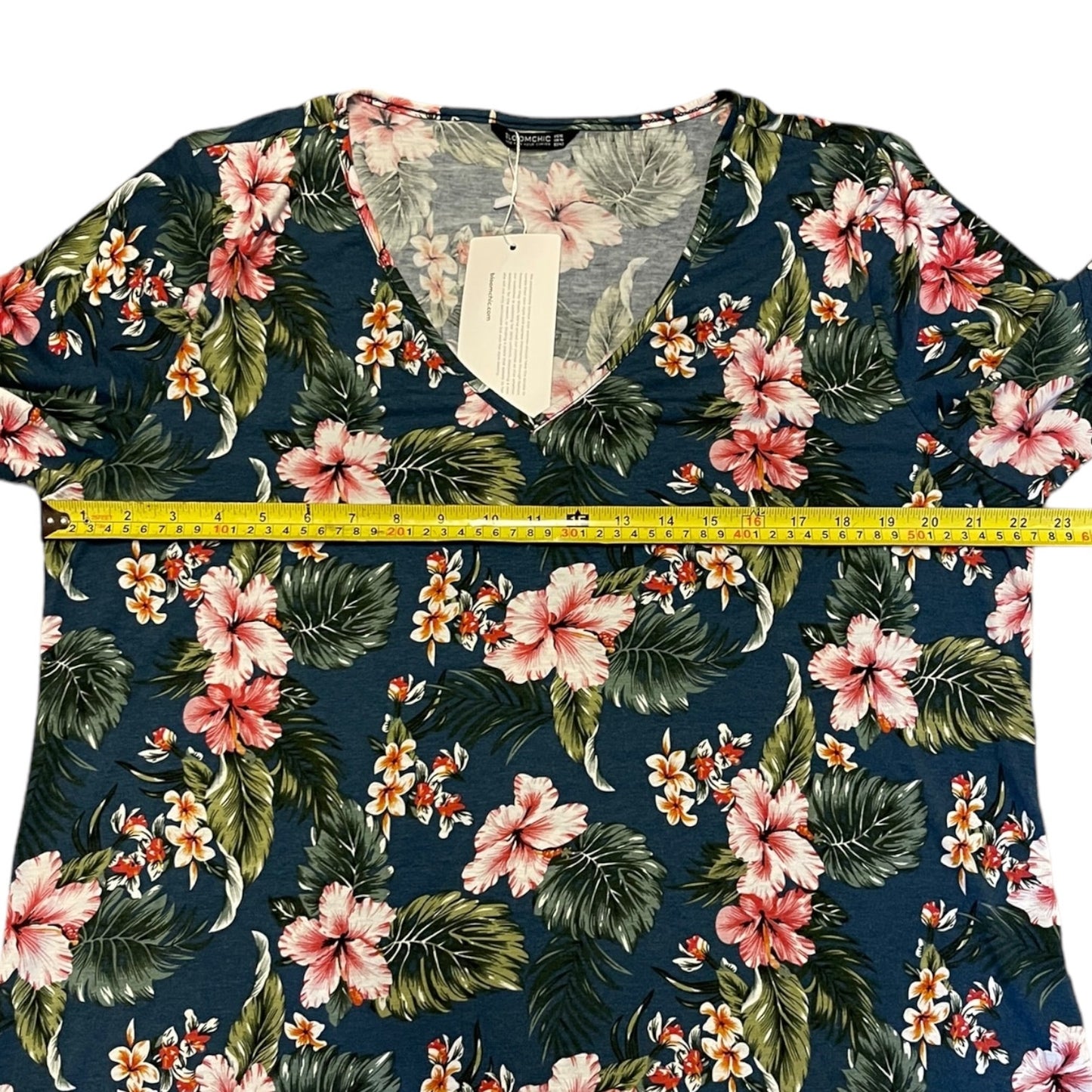 Floral-patterned shirt with a measuring tape on a white background