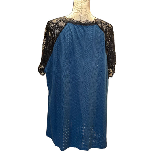 Blue shirt with black lace sleeves on a mannequin against a white background