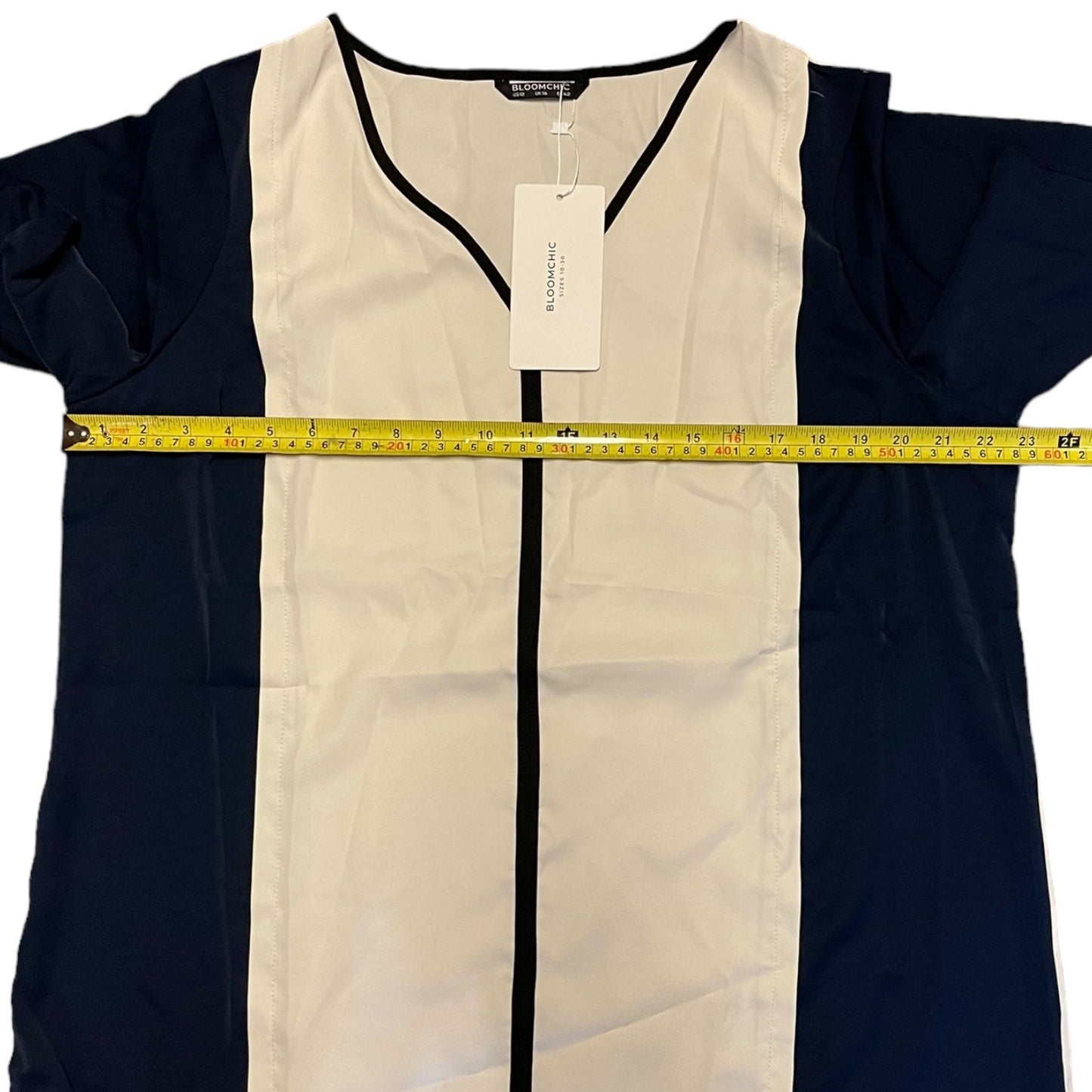 Two-tone shirt with a measuring tape across it on a white background