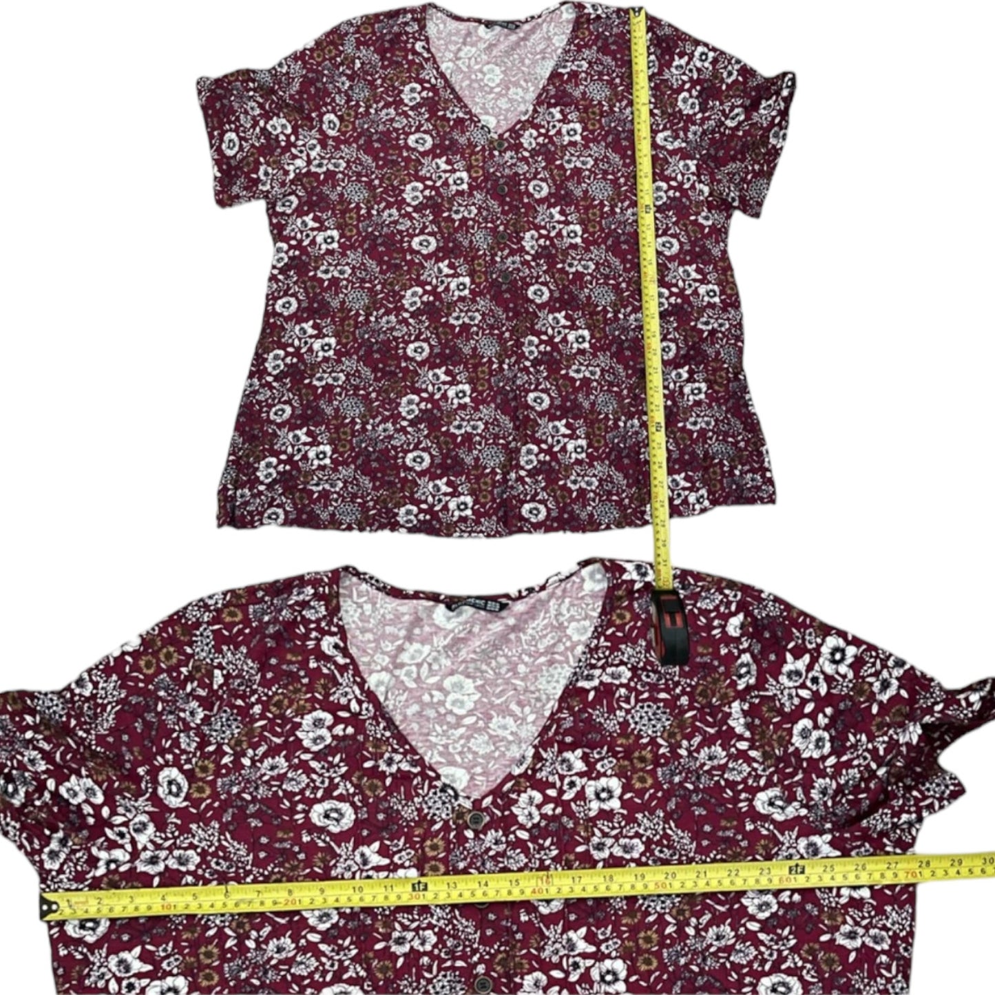 Floral-patterned top with a measuring tape for size reference on a white background