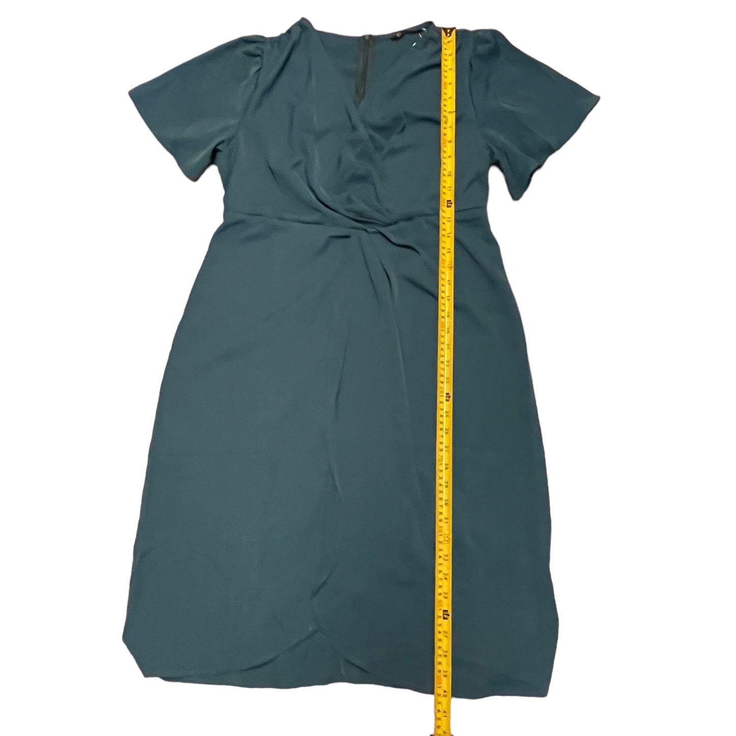 dress with a yellow measuring tape on a white background