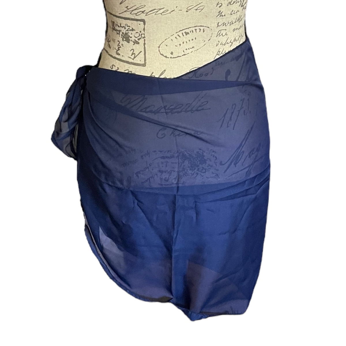 A navy blue sheer wrap sarong displayed on a cream-colored mannequin torso against a plain white background.