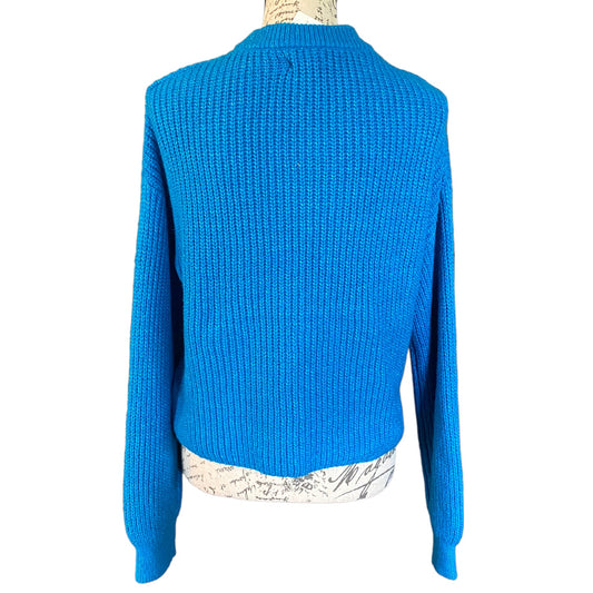 Back of a blue knit sweater on a mannequin on a white background
