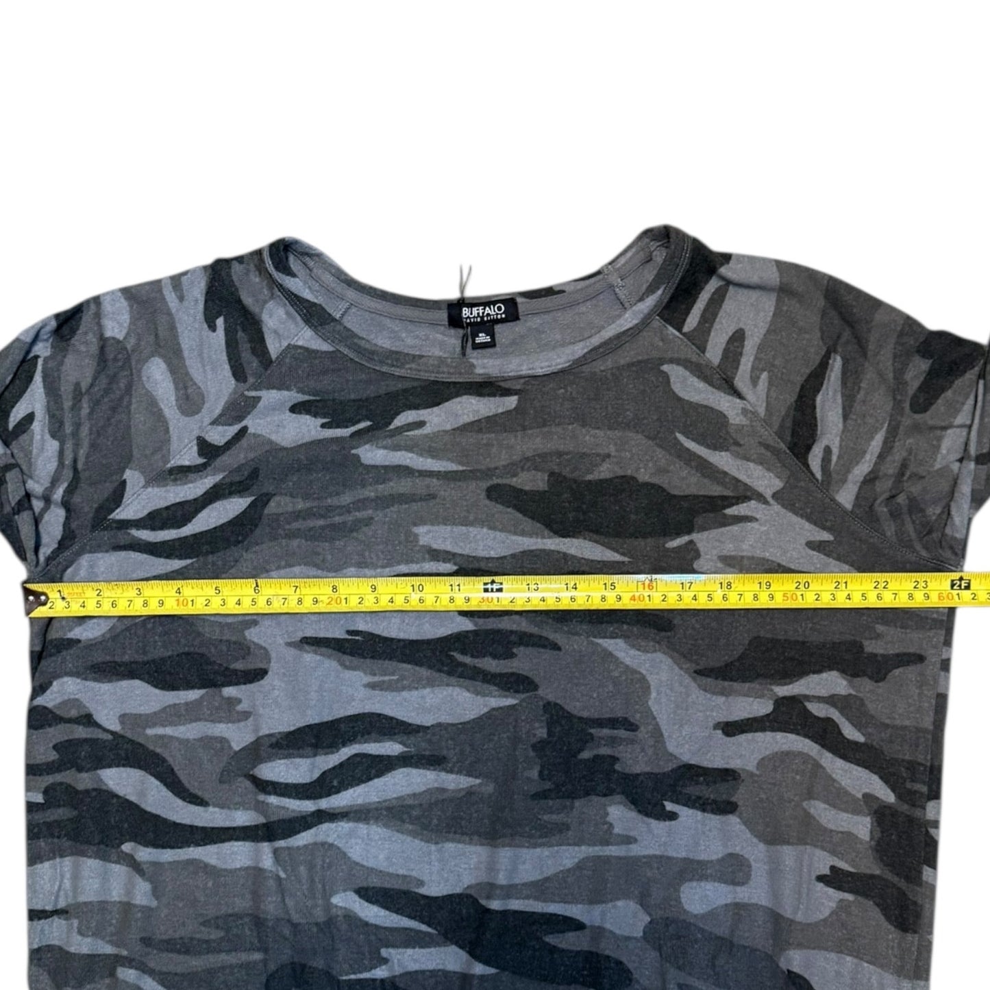Camouflage t-shirt with a measuring tape on a white background