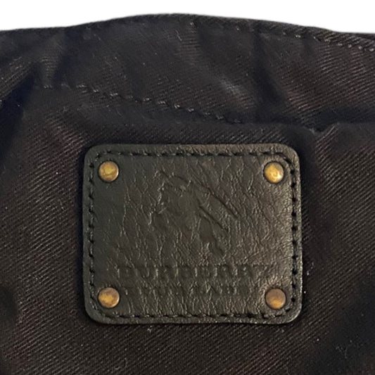 Close-up of a black leather label on a dark fabric background