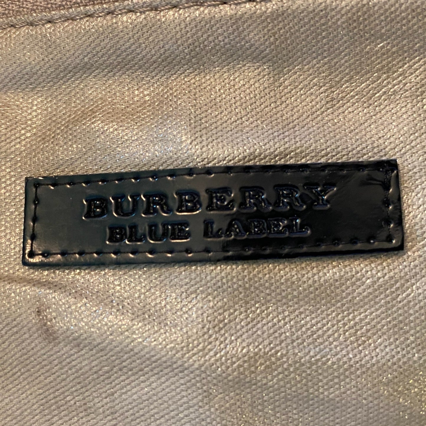 Burberry Blue Label label on a gold fabric background