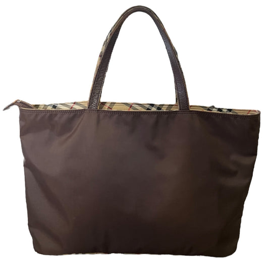 A dark brown nylon tote bag with dark brown leather handles and a beige plaid pattern lining visible along the top edge, set against a plain white background.