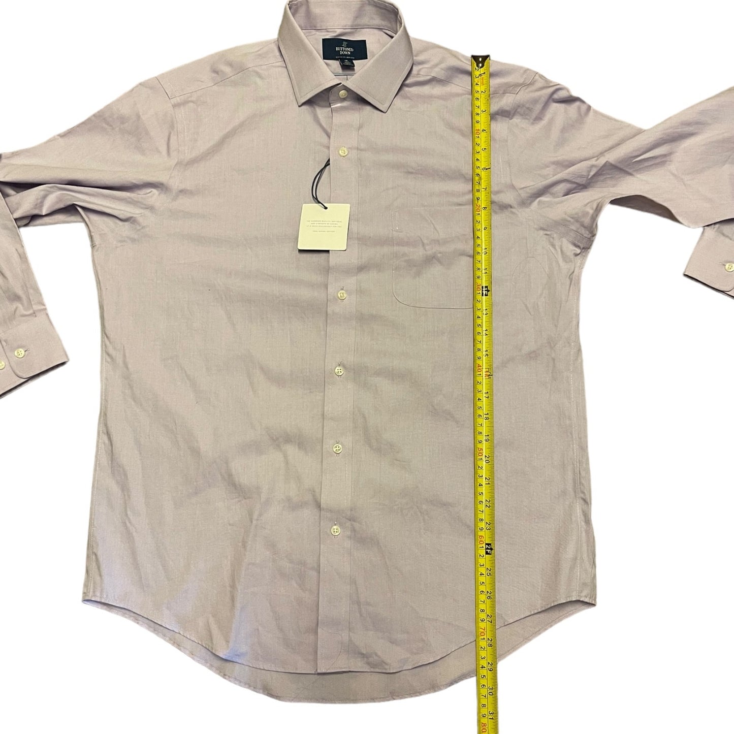 A light lavender long-sleeve button-down dress shirt laid flat on a white background, with a yellow tape measure standing vertically along the right side to show the garment's length.