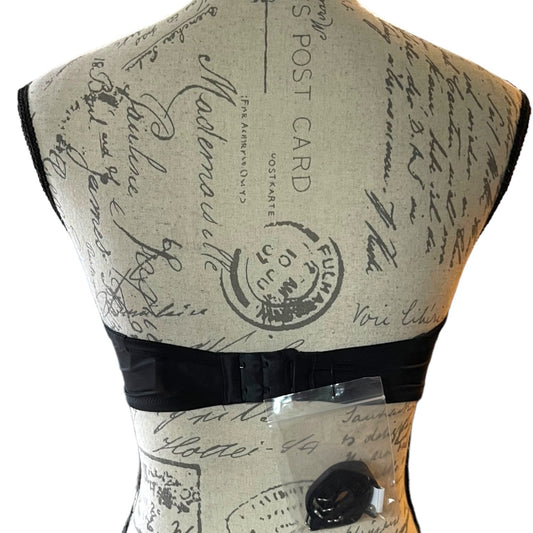 Back of black bra on Mannequin with vintage-style text and stamp design on a white background