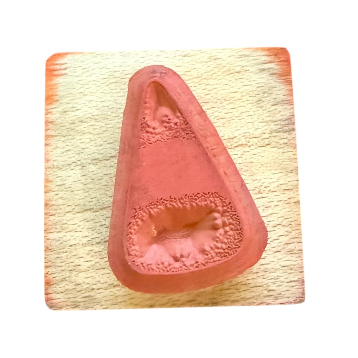 Candy corn rubber stamp mounted on a wood block on a white background.