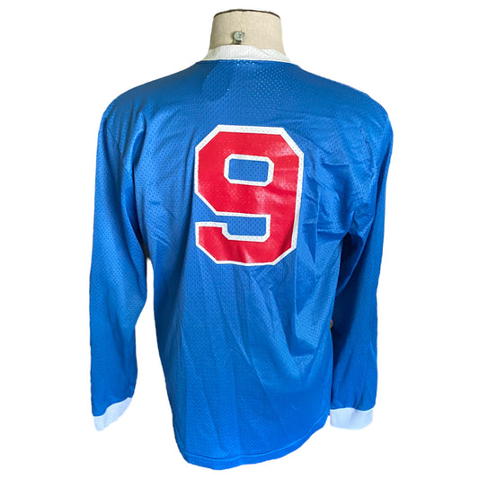 Back of blue shirt with long sleeve and a 9 on white background