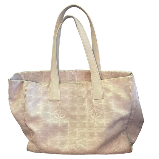Front of off white or beige purse with leather handles with a CC monogram on a white background.