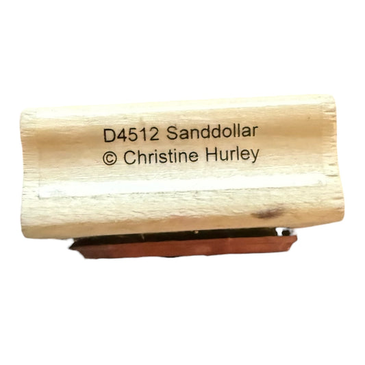 Wooden stamp with 'D4512 Sanddollar © Christine Hurley' text on a white background