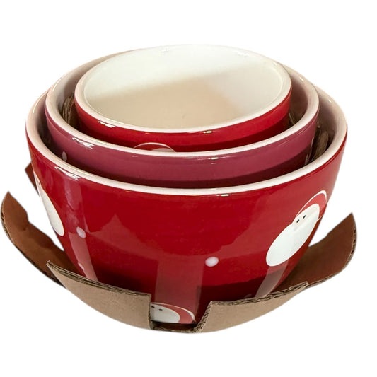 Set of red ceramic bowls with white polka dots on a cardboard base