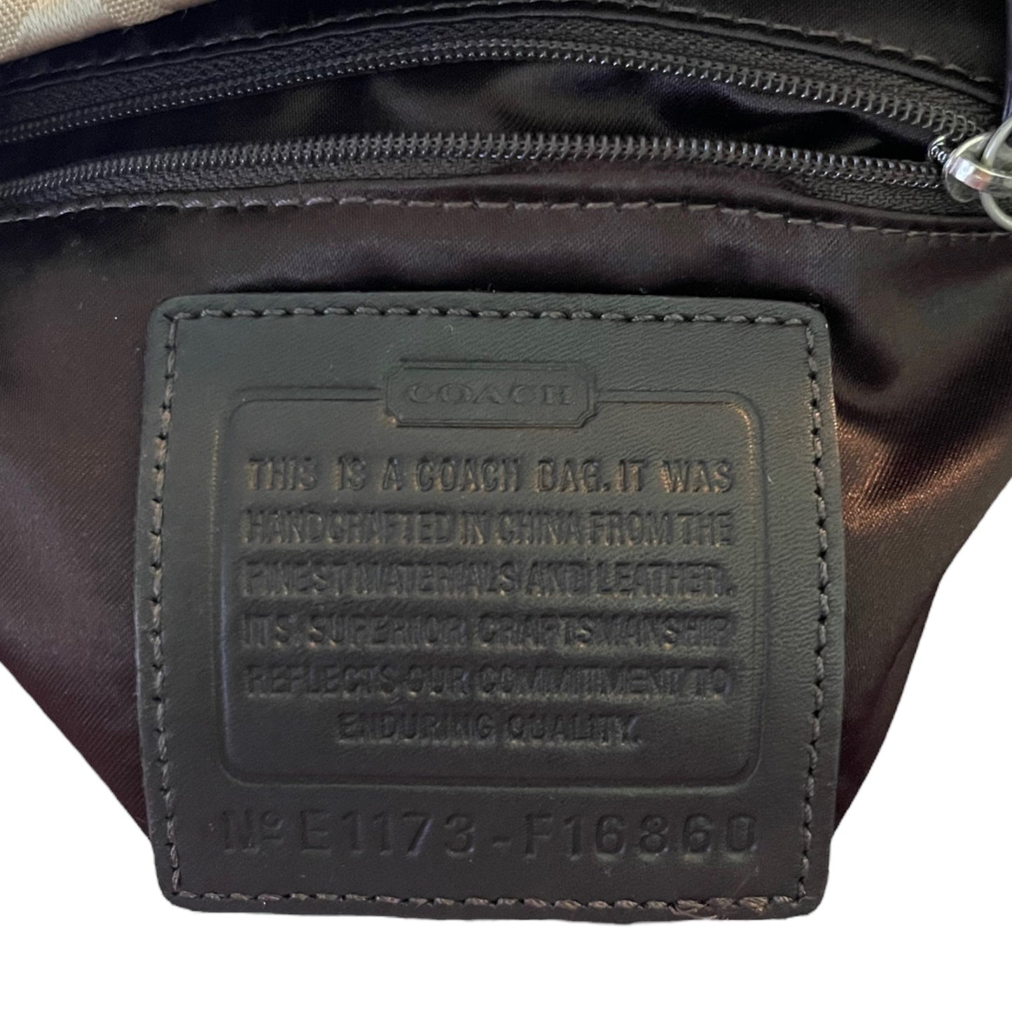Coach bag label on a dark brown leather bag