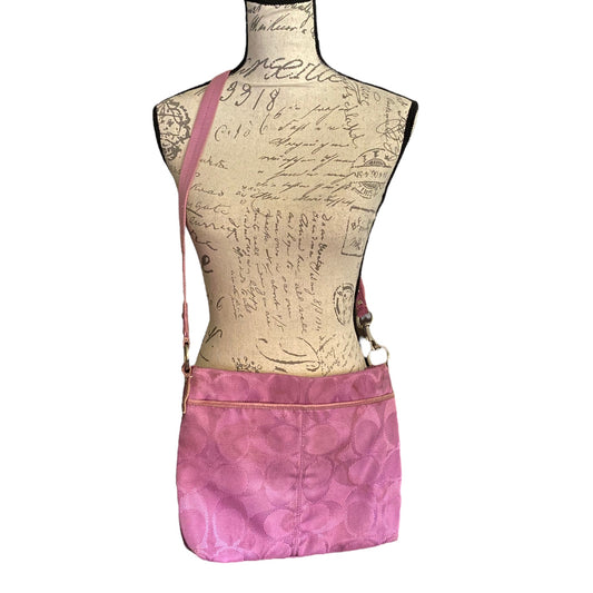 A purple crossbody bag with a CC pattern, displayed on a vintage-style printed dress form mannequin against a white background.