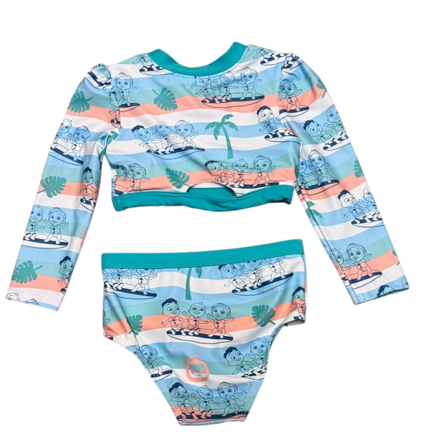 A two-piece baby swim set featuring a long-sleeve crop top and matching swim briefs. The set has a colorful Cocomelon print of children surfing on waves with a light blue, white, and peach stripe pattern, accented by teal trim.