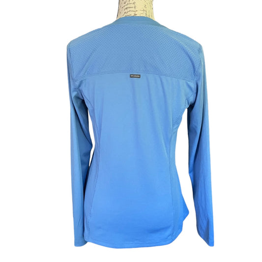 Back of Blue long-sleeve shirt on a mannequin with a white background