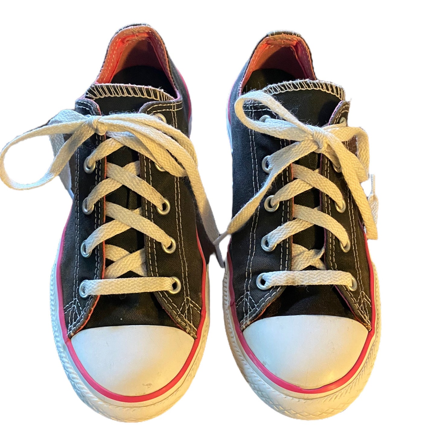 Pair of black sneakers with white laces on a white background