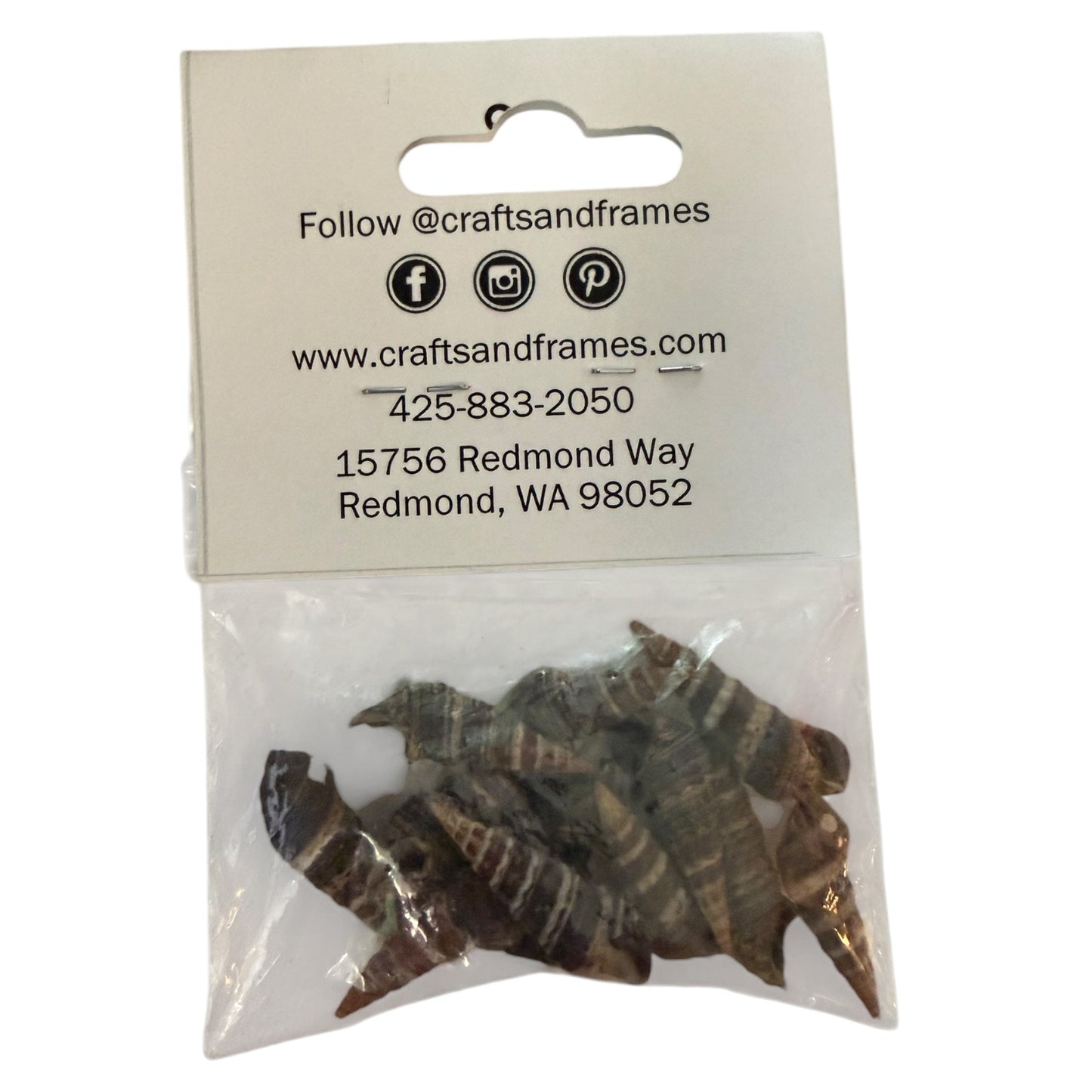 Packaged items with a clear window on a white label displaying contact information with shells