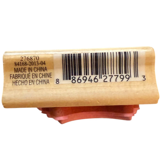 A close-up of a wooden stamp block with a barcode label and black printed text, showing 'MADE IN CHINA' and a red rubber stamp foot underneath, on a white background.
