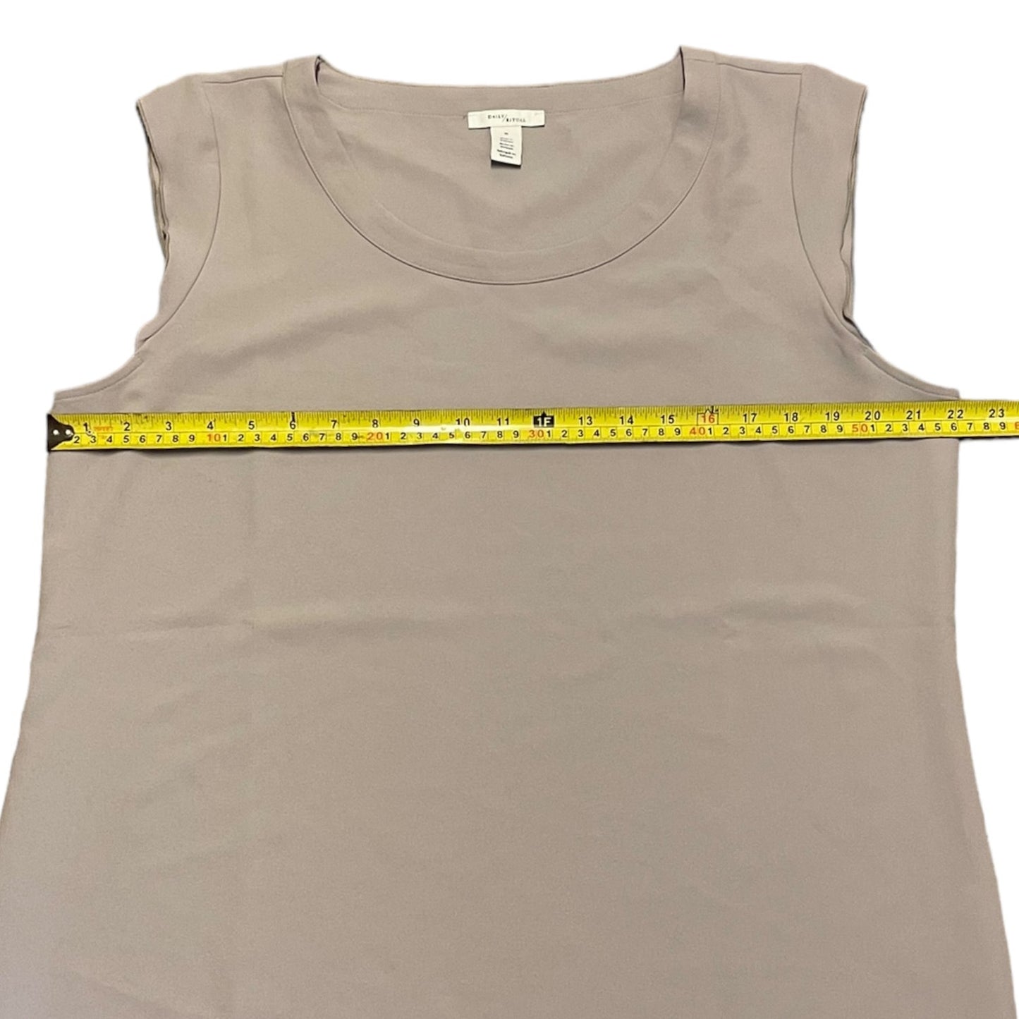 Gray tank top with a measuring tape on a white background
