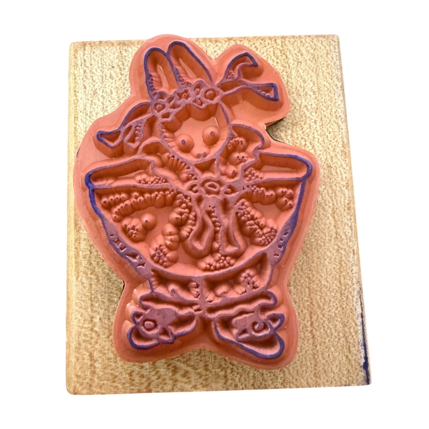 Decorative rubber stamp with a rabbit design on a wooden block