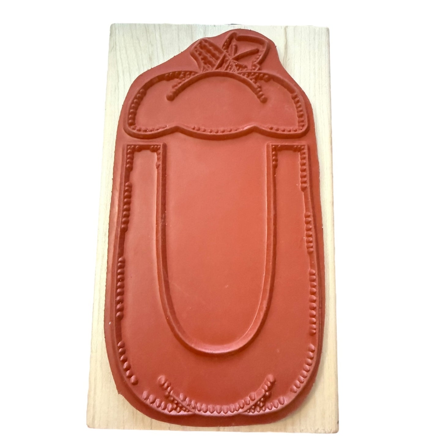 Pumpkin rubber stamp on a wooden block with a white background