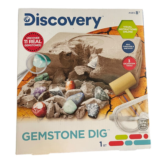 Discovery Gemstone Dig kit packaging with excavation tools and gemstones on a white background