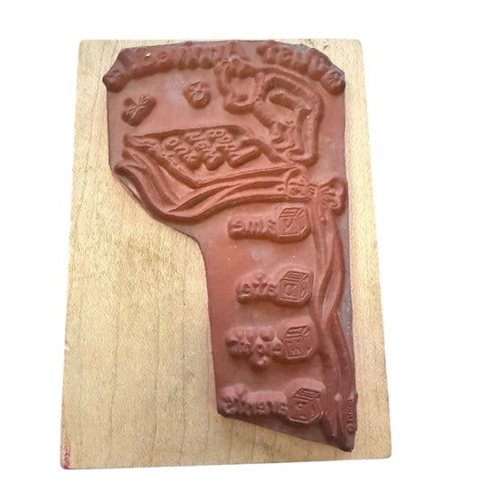 Rubber stamp on a wood block with a white background