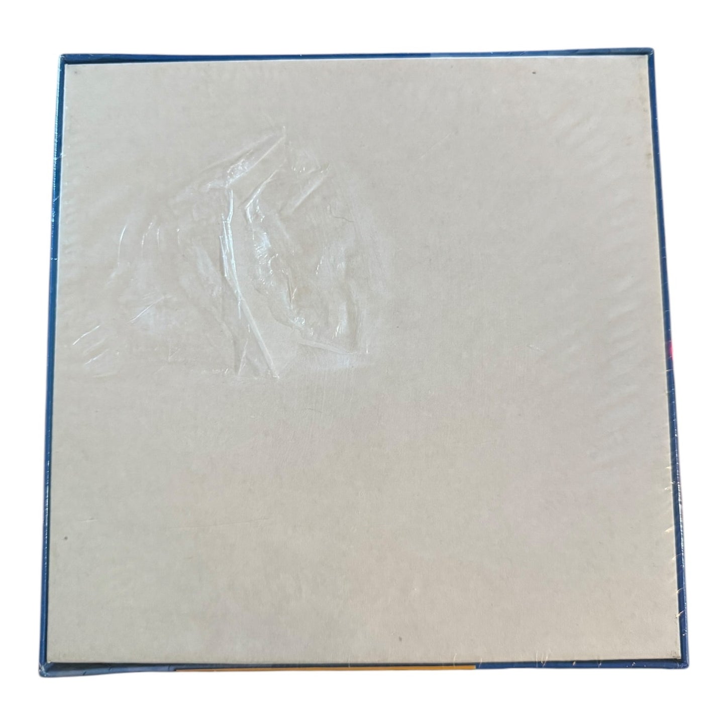 Back of puzzle box showing tear in the packaging on a white background